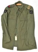 A scarce Jungle green Indian issue jacket, bearing RA slip ons and unit patches of 20th Indian