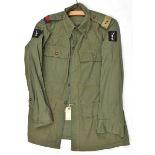 A scarce Jungle green Indian issue jacket, bearing RA slip ons and unit patches of 20th Indian