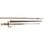 A Gras bayonet, d 1873 on backstrap, in scabbard (dark rust patina), and an African fishing spear,