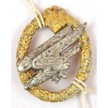 A scarce Third Reich Army Parachutist’s badge, of aluminium alloy, with gold anodised wreath and