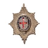 An officer’s silver field cap badge of the Coldstream Guards, blue and red enamelled centre, HM