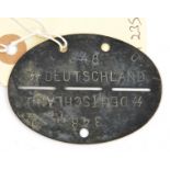 A German grey metal dog tag, stamped “348” and “SS Deutschland”. GC