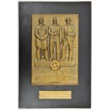 A Third Reich embossed thin brass rectangular plaque, 7” x 10”, depicting three workers above a