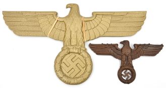 A brown painted cast brass eagle and swastika, 12” overall, the back of the swastika impressed “Henn