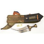 A N African jambiya, blade 8½” in sheath, on broad shoulder belt with embroidered panels. GC