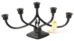 A Third Reich SS 5 branch candlestick, of blackened cast iron with entwined stems of diamond