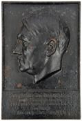 A black painted rectangular cast iron wall plaque, 8½” x 12½”, embossed with head of Hitler and