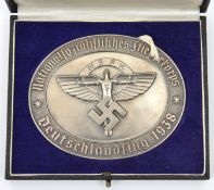 A Third Reich NSFK oval silvered metal plaque, 3¾” x 3”, the centre with NSFK “bird man” device,