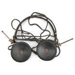 A pair of WWII period German headphones, of metal and bakelite construction, with cables. GC