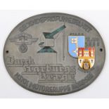 A Third Reich NSKK dashboard plaque (?) of oval grey metal, 3¾” x 3”, embossed with NSKK eagle, an