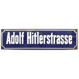 A German white on blue enamelled street sign “Adolf Hitlerstrasse”, 23” x 6”. GC (rust around