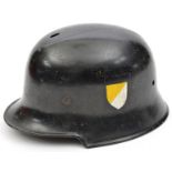 A Third Reich Police/Fire Brigade steel helmet, the black painted skull having 2 sets of 7 hole