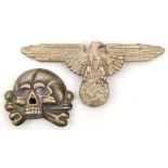 A Third Reich white metal SS cap eagle with death’s head, the first with RZM and “M1/52” marks, with