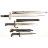 A Portuguese M1885 bayonet, in scabbard; a Russian bayonet for the AK47 assault rifle; and an