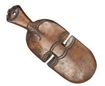 A Maori wooden club Kotiate, 12½” long, with incised cut patterns, the pommel with stylised human