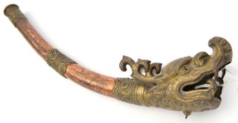 A Tibetan brass and copper temple trumpet, of slightly curved, tapering form, with scroll embossed