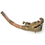 A Tibetan brass and copper temple trumpet, of slightly curved, tapering form, with scroll embossed