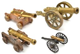 A model cannon, brass barrel 6½” of good shape, on its 4 wheeled cast iron naval type carriage,