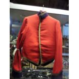 An officers scarlet mess jacket, blue facings, gilt lace trim (collar badges missing), and blue