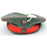 A WWI pattern German soft peakless cap (feldmutze), with national and Prussian rosettes, the