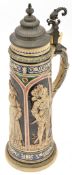 A German 2 litre beerstein, of glazed stoneware, embossed with panels depicting 2 knights in