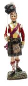 A painted porcelain figure “Seaforth Highlanders, 1815”, in full dress with Highland bonnet, holding
