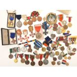 An accumulation of various medals, commemoratives etc including: British Red Cross Society