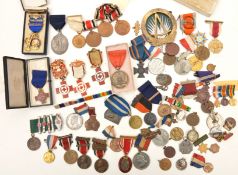 An accumulation of various medals, commemoratives etc including: British Red Cross Society