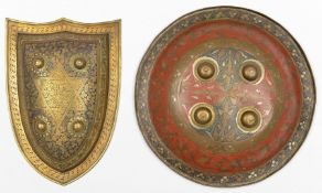 An Indian Benares circular brass shield, 14” diameter, with 4 bosses and decorated in red and