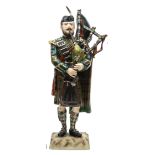 A “Kingsman Collection” painted porcelain figure “Pipe Major Queens Own Highlanders” in full