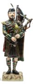 A “Kingsman Collection” painted porcelain figure “Pipe Major Queens Own Highlanders” in full