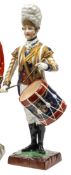 A painted porcelain figure “Drummer 3rd Guards”, in Georgian full dress with white mitre style fur