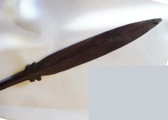 A Polynesian darkwood paddle, 71” overall, of simple spear form, made in one piece, thickened tip to