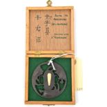 A Japanese tsuba, engraved Kofu Ju Masayoshi (18th C), carved with 3 minogami (turtles), in a