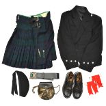 A Highland piper’s black cloth uniform, doublet, kilt with miniature broadsword and dirk pins,
