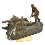 A WWI bronzed spelter model of a French 75mm field gun, with gunner in the act of loading a shell,