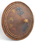 A Chinese peasant’s shallow conical hat, 25½” diameter, constructed from fine strips of bamboo