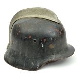 A Third Reich Fire Service steel helmet, painted black over red, with aluminium crest, leather liner