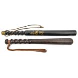 A truncheon, with tapered ribbed grip and bun finial, painted smooth black with gold crown over “