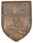 A bronzed cast lead example of the Warsaw shield, pierced around the edge with 4 small holes for