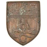 A bronzed cast lead example of the Warsaw shield, pierced around the edge with 4 small holes for