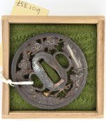 A Japanese tsuba, chiselled with fisherman inlaid with shakudo silver and copper gilt. GC in a case.
