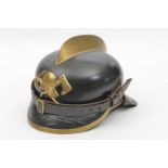 A German fireman’s leather helmet, pickelhaube style skull with brass edge bound front peak and