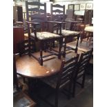 AN EXTENDING OAK DINING TABLE AND 6 CHAIRS