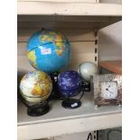 FOUR SMALL GLOBES AND A CLOCK