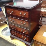 A REPRODUCTION MAHOGANY CHEST OF FOUR DRAWERS