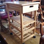 A LIGHT WOOD KITCHEN TROLLEY