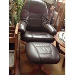 A BROWN LEATHERETTE SWIVEL CHAIR AND STOOL