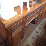 A VICTORIAN OAK SIDEBOARD WITH CARVED PANELS AND CENTRAL BELOW TWO DRAWERS L200CM D35CM H87CM