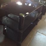 A BLACK GLASS TV STAND